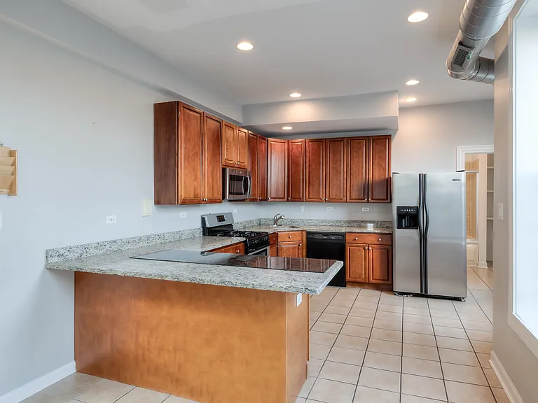 HUGE Kitchen with stainless steel appliances and granite counter tops.