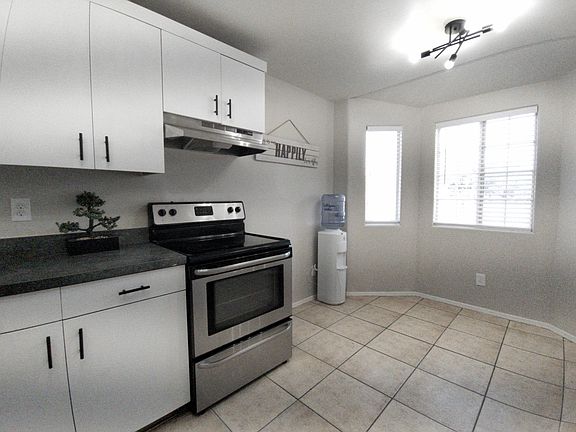 Electric range and plenty of kitchen cabinets.