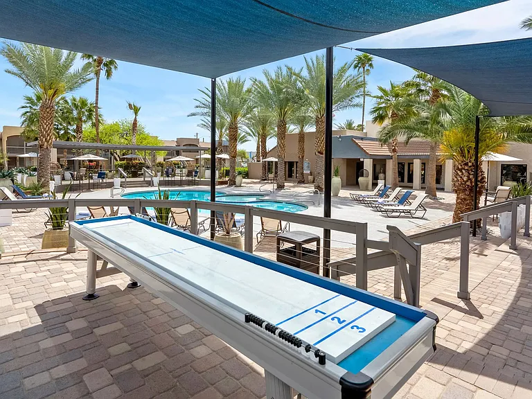 Join the spirited shuffleboard games by the pool where the shade keeps you cool and the competition heats up.
