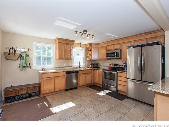 Large kitchen with stainless steel appliances and granite counter-tops.