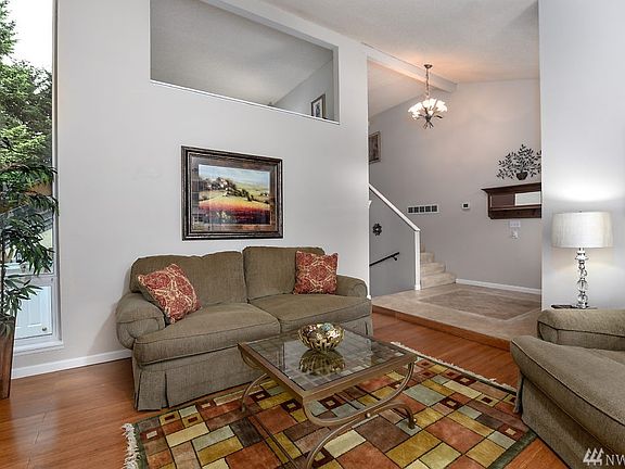 Vaulted formal living room with wood burning fireplace:  think of the holiday trees you can have in this room!