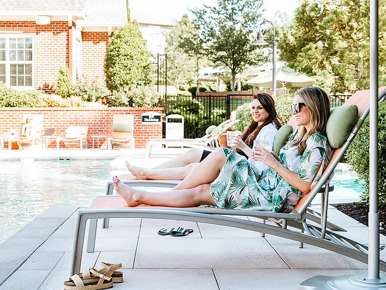 Resort-style pool with shaded lounge seating