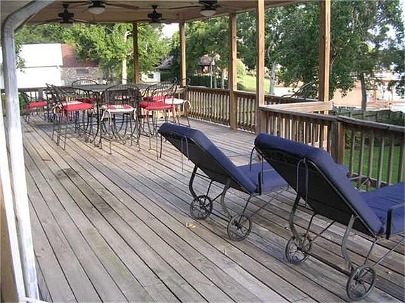 LARGE BACK DECK  IS FULL LENGTH OF BACK OF HOUSE AND WRAPS AROUND SIDE TO FRONT ENTRY