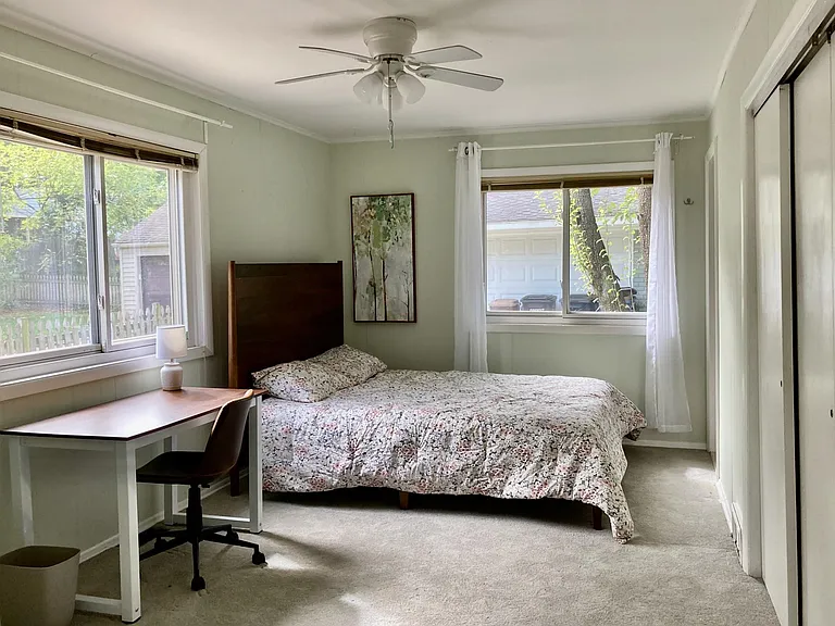 View of the first-floor master bedroom, with a full bathroom and two window exposures. The door leading to the master bedroom is off the family room.