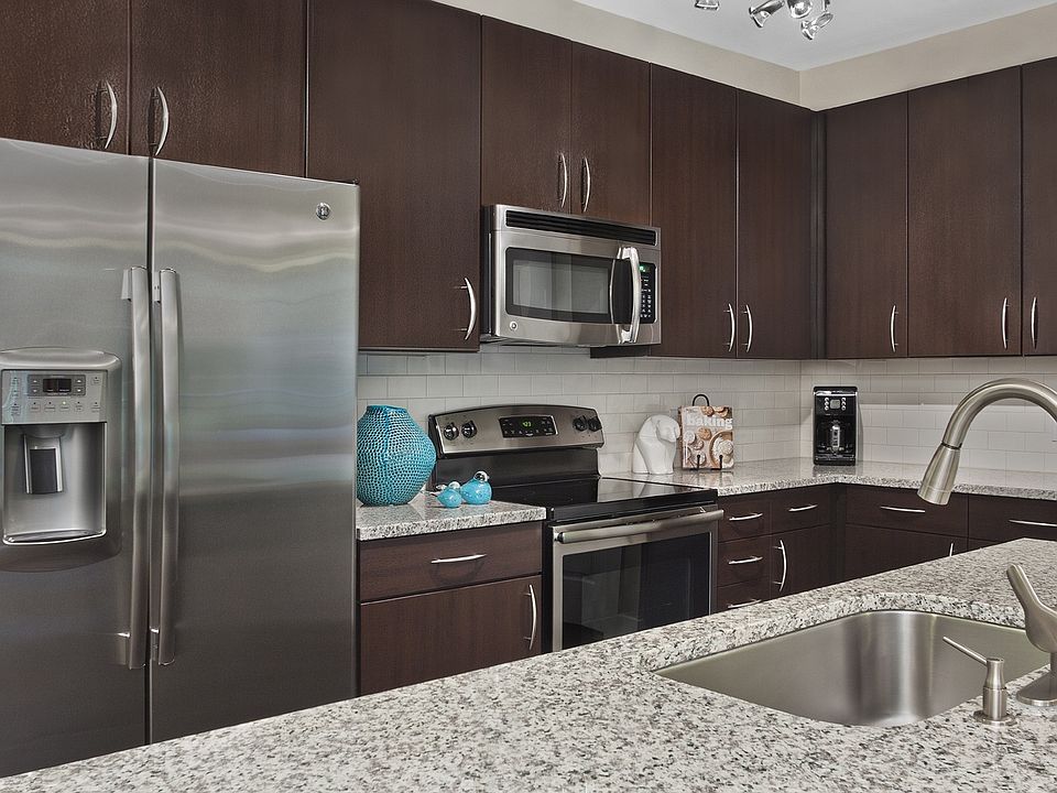 Kitchens with granite counters, subway tile backsplash and side-by-side stainless steel refrigerator with exterior ice/water dispenser