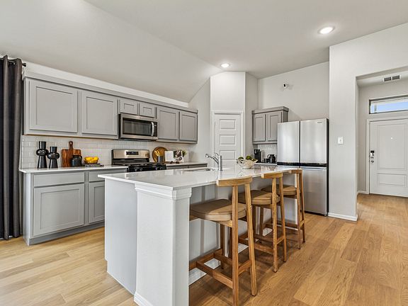 Kitchen in the Turquoise home plan by Trophy Signature Homes - REPRESENTATIVE PHOTO