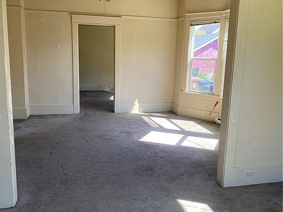 Big dining area with bay window. See all of the original mouldings throughout. Imagine fresh paint, flooring and fixtures.