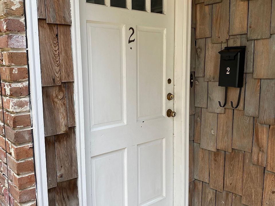 Front Door to Apartment 2 with exterior light and mailbox