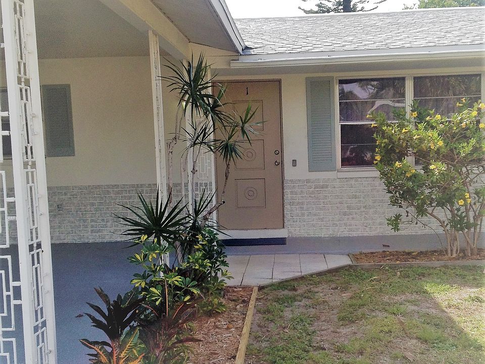 Front view, Carport to the left, covered doorway