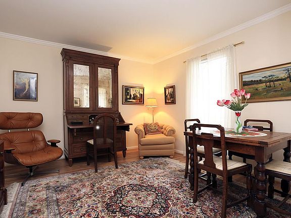 Cozy LIVING ROOM-11x12-featuring crown molding, fresh paint and recent.flooring.
