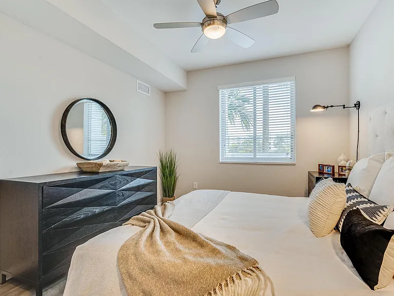 Bedroom with Double Nightstands, Light-Toned Flooring, and Framed Window for Natural Light