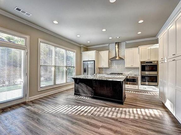 Love all the light that makes this area so cozy Photo is not of actual homesite.