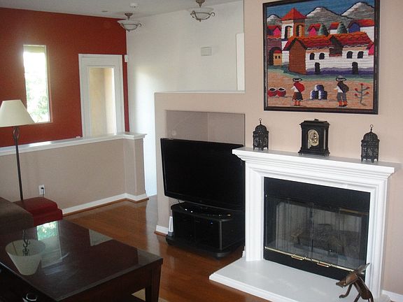 Living room with wood flooring, gas F/P, media niche