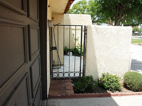Charming gated front courtyard for added privacy and curb appeal