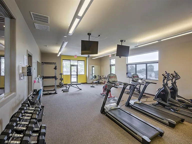 Treadmills and dumbells in the gym at Avenue 204.
