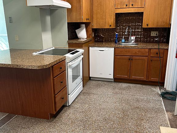 Kitchen with dishwasher, stove, larger island