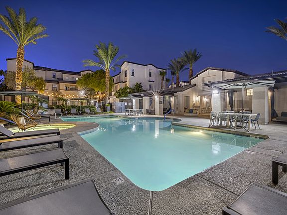As the sun sets and twilight takes over, the pool transforms into a serene oasis, with ambient lighting enhancing the luxurious feel of the surroundings.