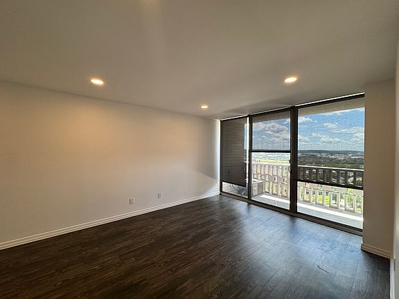 Updated living/dining room features dimmable, efficient LED lighting, new roller shades, and luxury vinyl flooring.