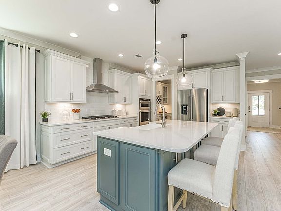 Luxurious Kitchen with Stainless Steel Appliances and Tile Backplash