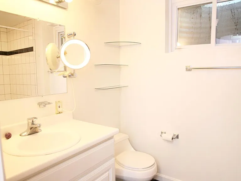 Full bathroom on lower level with heat lamp.