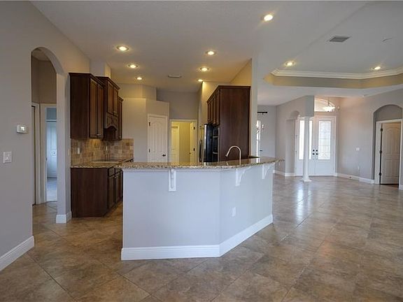 View of Kitchen / partial view of Family Room / Front Door.  Entry into Master Bedroom to the right of front door.
