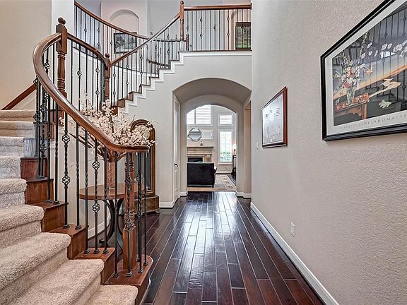 Come on in! Let the memories begin! Stunning split staircase with iron railing.