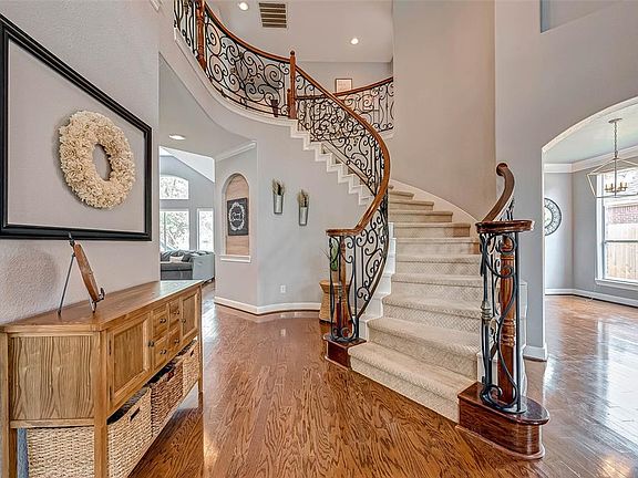 At the foyer you are welcomed by shiny wood floors with a carpeted staircase with detailed stair rails. SO pretty!