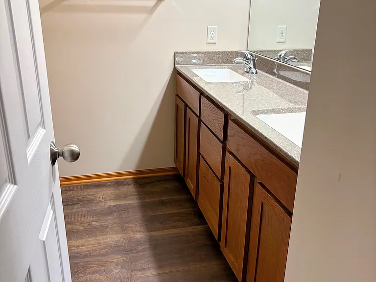 Primary Bedroom bath with solid surface dual sinks with LVT flooring!