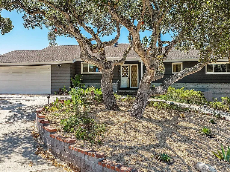 Front of house with circular driveway.