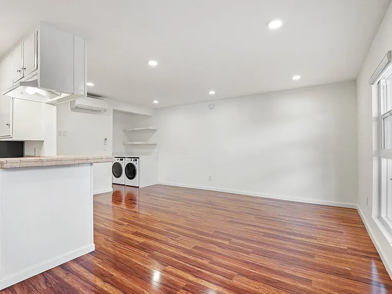 Kitchen, Dining, and Living Room Space with Recessed Lighting, Vinyl Flooring, and Large Windows