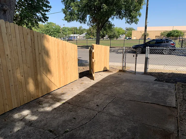 Back of yard with door to parking spot