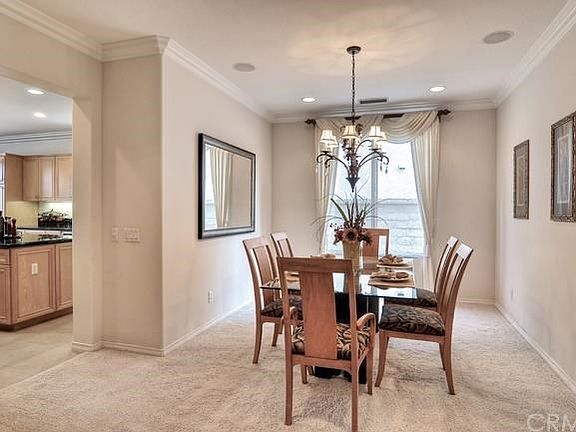 Formal dining with speakers and crown molding