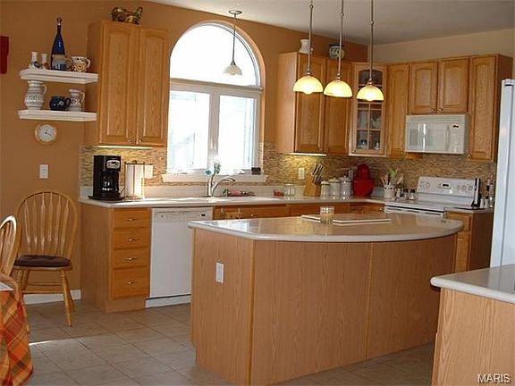 Fabulous kitchen with 42" cabinets, Corian counters, ceramic floors, tile backsplash, smooth top stove, microwave, dishwasher & pull-outs!