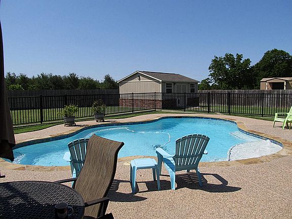 Exquisitely manicured grounds with brick veneer storage building, recent pool w/ fountain and security fence and pergola.