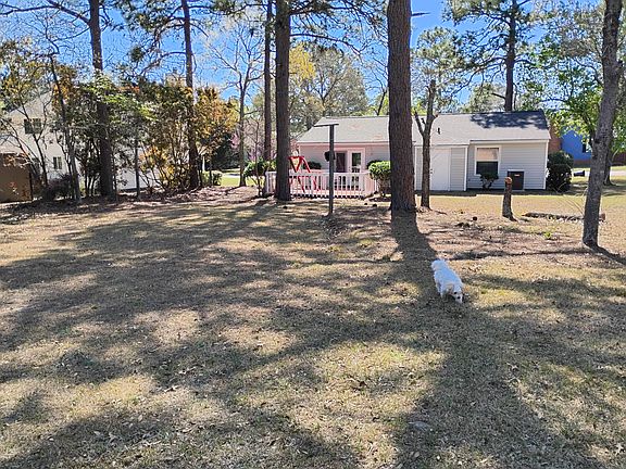 Large back yard faces Woodland Golf course. Patio for enjoying the evenings surrounded by large trees.