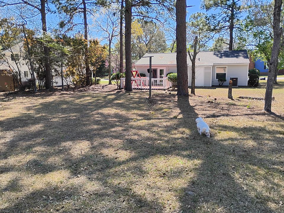 Large back yard faces Woodland Golf course. Patio for enjoying the evenings surrounded by large trees.