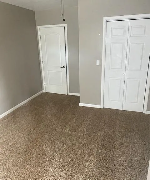 Floors are now hard surface plank in living room. Room now has a sofa, love seat, table and two chairs.