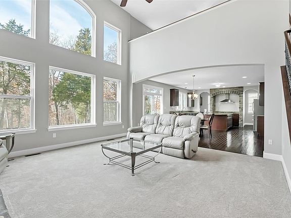 Open floor plan from great room to kitchen with stone surround cooktop