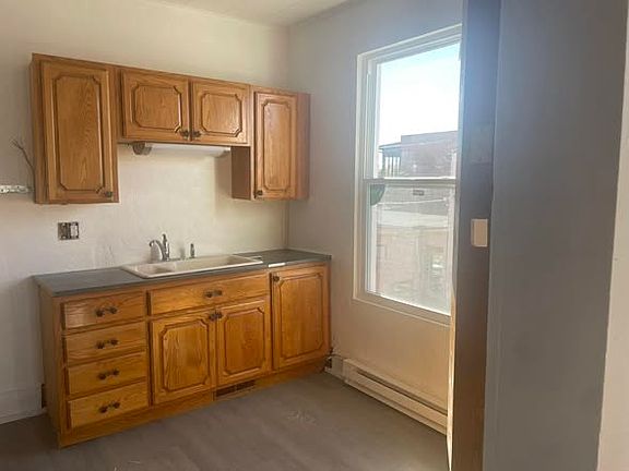 Part of kitchen. Lots of cabinet space on opposite wall.