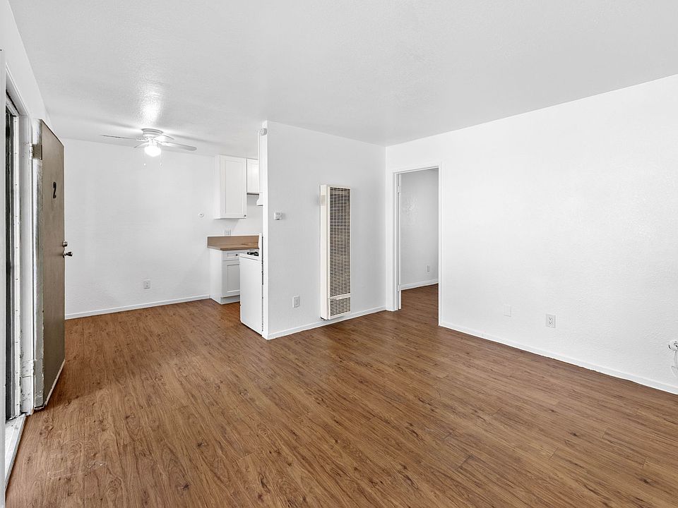 Living room to kitchen and dining area with new fan, all new paint throughout, all new appliances