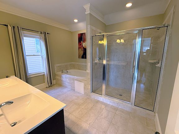 The entire top floor is the Primary Suite with King Bed, TV, sitting area (multi-purpose), large walk-in closet, and enormous en suite bathroom with double vanities, Whirlpool Tub & separate dual head shower for 2!