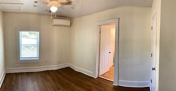 bedroom with minisplit heating/cooling unit, and new ceiling fan