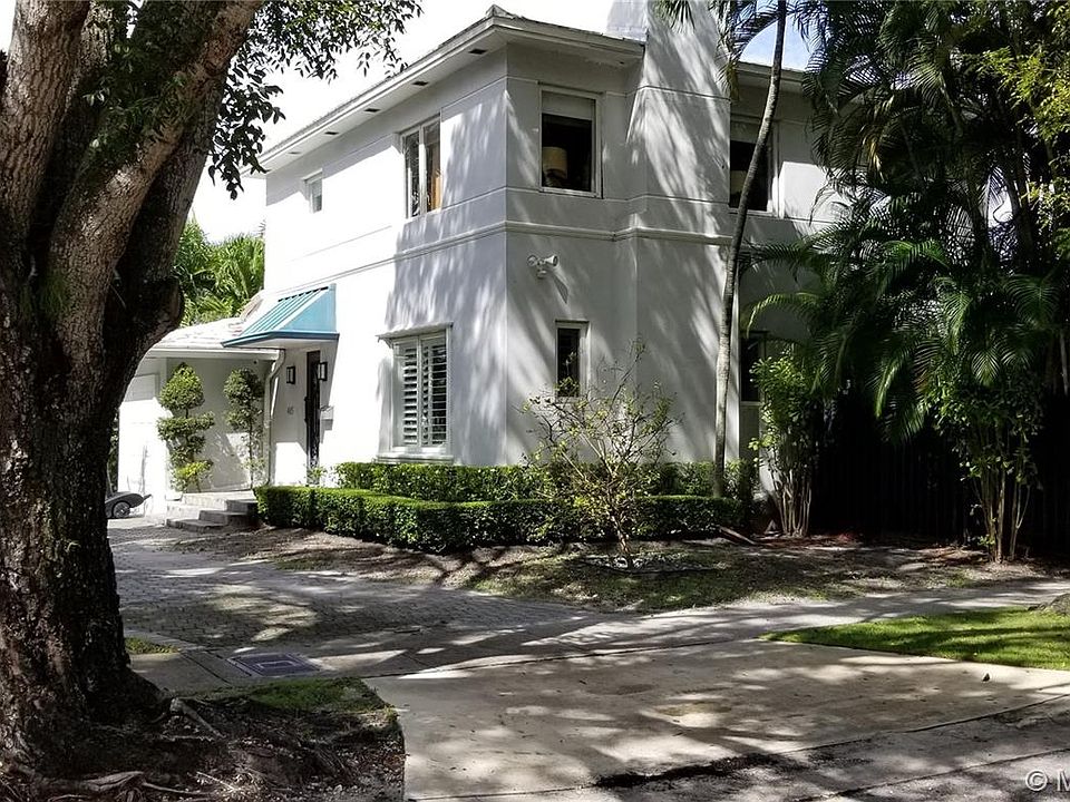 Circular driveway shaded by matured oak trees