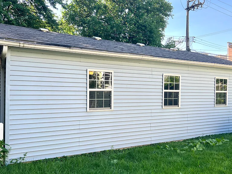 Three car garage with remote. Also, a large driveway in front.