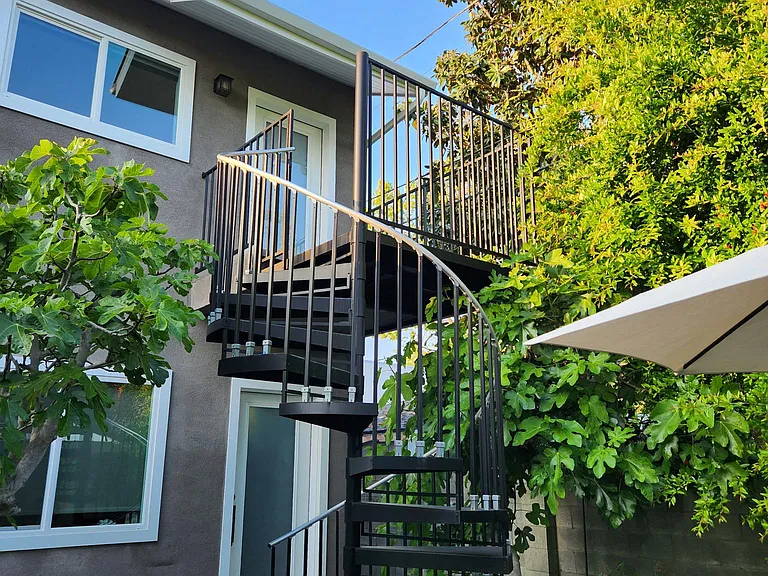Beautiful spiral staircase leading up to the studio unit