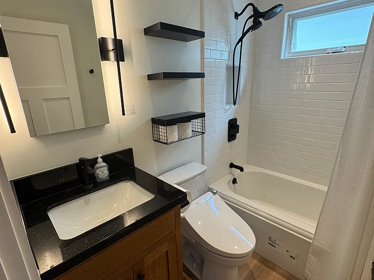 Bathroom with soaker tub and shower along with a Toto Washlet. Granite top vanity.