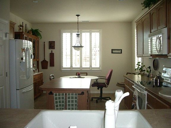 This kitchen has everything, island with storage and work space, nook for dining, extra space for a 