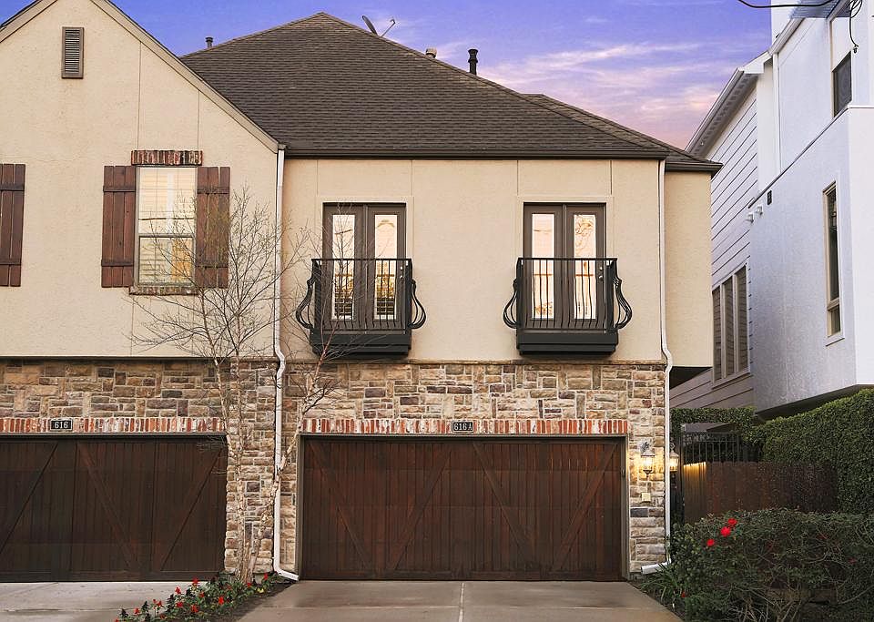 Exterior Elevation: Beautiful stone and stucco with decorative balconies and upgraded garage door w/ key pad entry