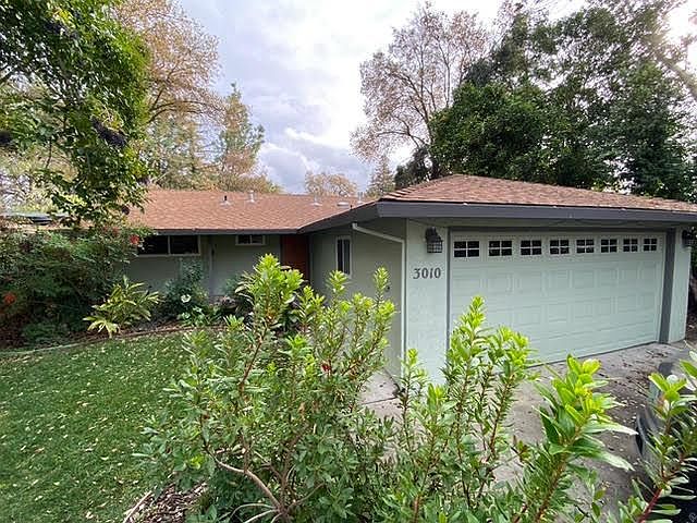 Front of Home, Garage & front yard. Check out the beautiful trees/sky in the background
