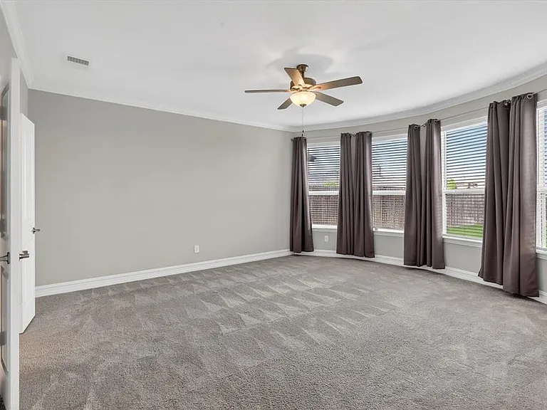 Room featuring light gray walls, gray carpeting, and white baseboards